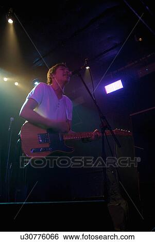Stock Photograph - Lead vocalist with guitar. Fotosearch
