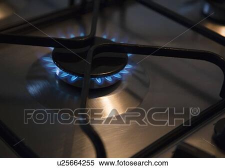 Stock Photography - Lit gas ring on oven hob. Fotosearch