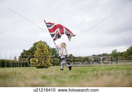 Little girl holding up flag View Large Photo Image Stock Image - Little girl holding up flag. Fotosearch