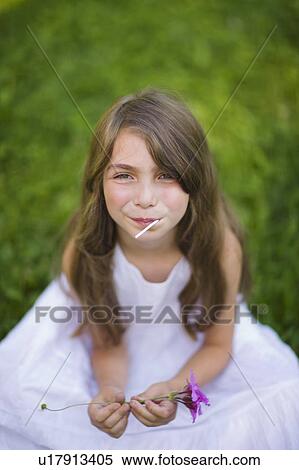 Stock Photography - Little girl in the backyard. Fotosearch