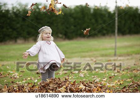 Little girl throwing leaves in the air View Large Photo Image Stock Image - Little girl throwing leaves in the air. Fotosearch