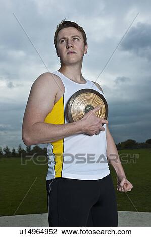 Male athlete posing with discus View Large Photo Image Stock Image - Male athlete posing with discus. Fotosearch