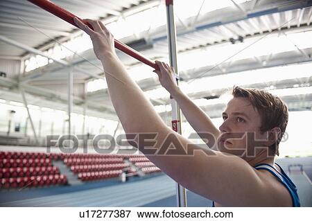 male athlete setting high jump bar View Large Photo Image Stock Photo - male athlete setting high jump bar. Fotosearch