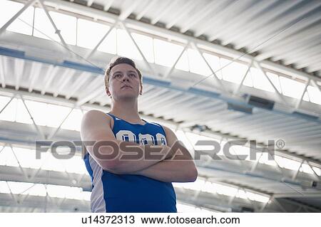 Stock Image - male athlete with arms folded. Fotosearch