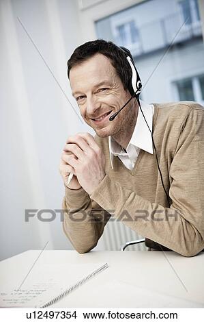 Male call center agent smiling View Large Photo Image Picture - Male call center agent smiling. Fotosearch