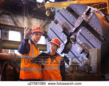 Stock Photography - Male & Female Steel Engineers In Factory. Fotosearch