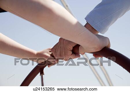 Man and boy steering yacht View Large Photo Image Stock Photography - Man and boy steering yacht. Fotosearch