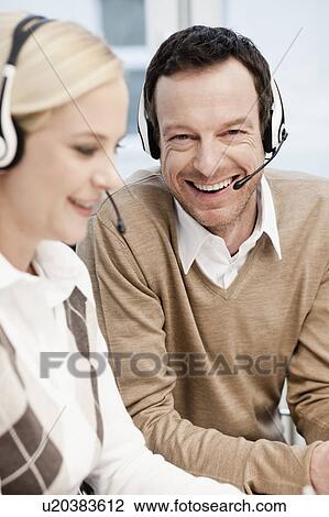 Man and woman in call center View Large Photo Image Stock Image - Man and woman in call center. Fotosearch