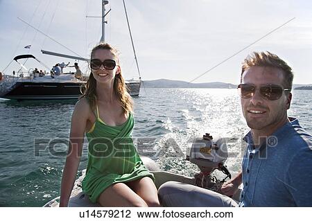 Man and woman in yacht dinghy View Large Photo Image Stock Image - Man and woman in yacht dinghy. Fotosearch