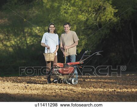 Stock Photo - Man and woman posing in field. Fotosearch