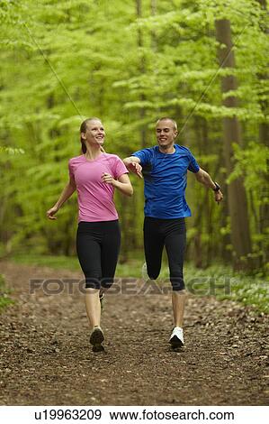 Man and woman running, competing View Large Photo Image Stock Photo - Man and woman running, competing. Fotosearch