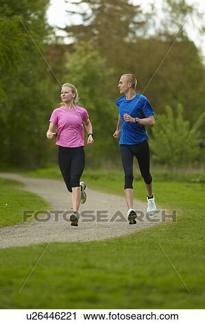 Man and woman running in nature View Large Photo Image Stock Image - Man and woman running in nature. Fotosearch