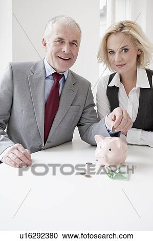 Stock Image - Man and woman saving money. Fotosearch