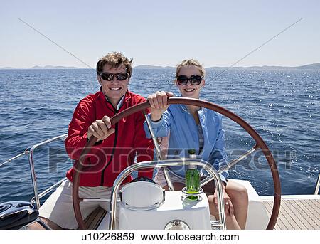 Man and woman steering yacht View Large Photo Image Stock Photo - Man and woman steering yacht. Fotosearch