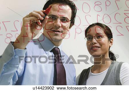 Man and women work on figures on glass View Large Photo Image Stock Image - Man and women work on figures on glass. Fotosearch