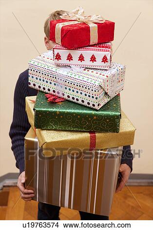 man carrying pile of presents View Large Photo Image Picture - man carrying pile of presents. Fotosearch