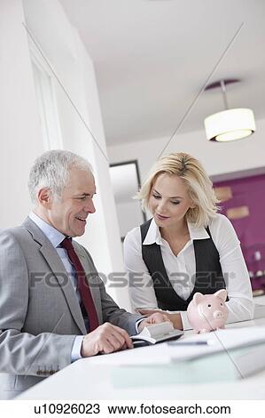 Stock Image - Man counseling young woman. Fotosearch