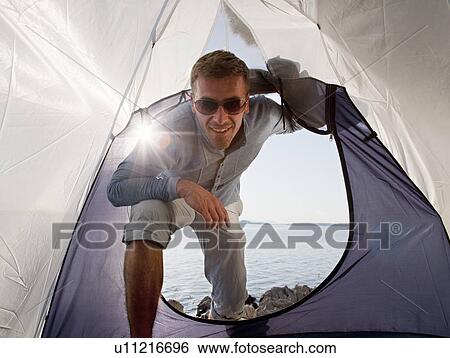 Man entering tent by sea View Large Photo Image Stock Photograph - Man entering tent by sea. Fotosearch