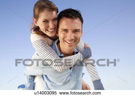Man giving woman piggyback View Large Photo Image Stock Photography - Man giving woman piggyback. Fotosearch
