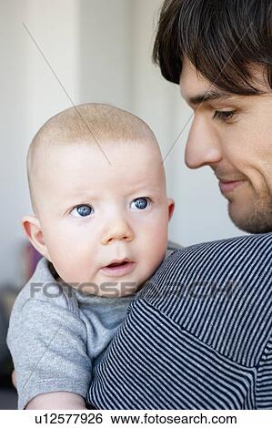 Man holding baby View Large Photo Image Stock Photograph - Man holding baby. Fotosearch