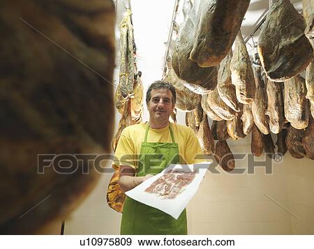Man holding freshly sliced ham View Large Photo Image Stock Photo - Man holding freshly sliced ham. Fotosearch