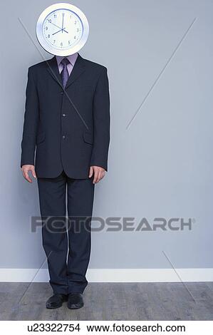 Picture - man in a suit with a clock head. Fotosearch