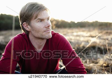 Man in open field during sunset View Large Photo Image Stock Image - Man in open field during sunset. Fotosearch