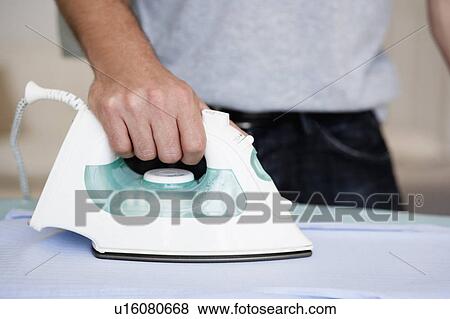 Stock Photo - Man ironing close-up. Fotosearch