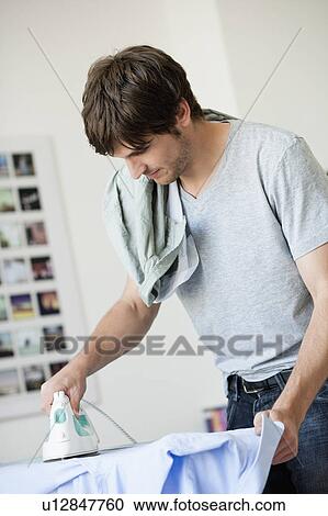 Stock Image - Man ironing. Fotosearch