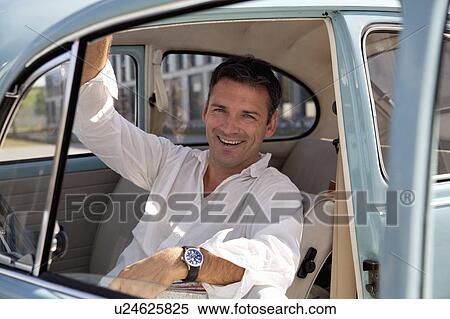 Man looking through car window View Large Photo Image Stock Photography - Man looking through car window. Fotosearch