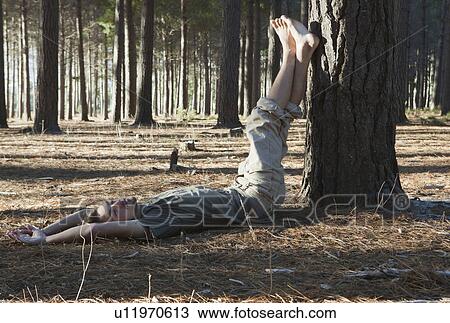 Man lying on ground in forest View Large Photo Image Stock Image - Man lying on ground in forest. Fotosearch