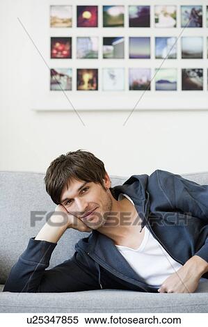 Man on couch View Large Photo Image Stock Photography - Man on couch. Fotosearch
