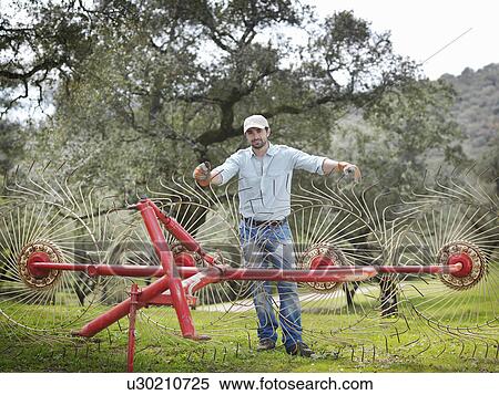 Man on farm with hay rake View Large Photo Image Stock Photography - Man on farm with hay rake. Fotosearch