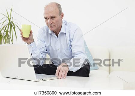 Man on laptop View Large Photo Image Stock Image - Man on laptop. Fotosearch