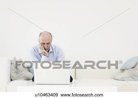 Man on laptop View Large Photo Image Stock Photo - Man on laptop. Fotosearch