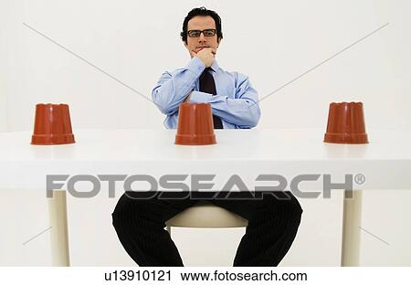 Stock Image - Man ponders location of hidden item. Fotosearch