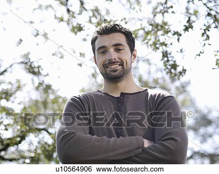 Man posing with crossed arms View Large Photo Image Stock Photograph - Man posing with crossed arms. Fotosearch