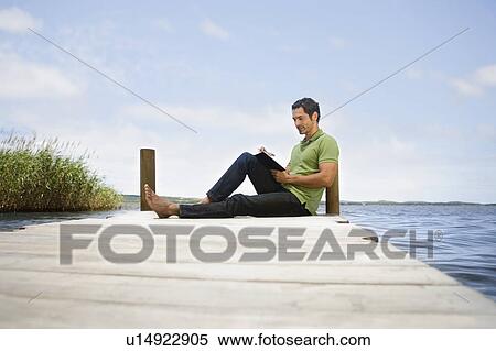 Man reading a book View Large Photo Image Stock Photography - Man reading a book. Fotosearch