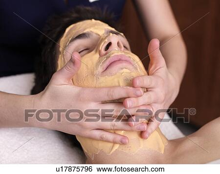 Stock Photograph - Man receiving facial massage. Fotosearch