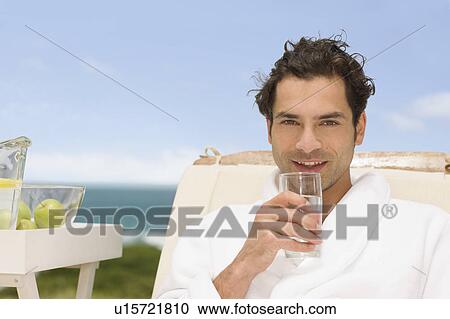 Man relaxing at the beach View Large Photo Image Stock Image - Man relaxing at the beach. Fotosearch