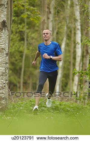 Man running in forest View Large Photo Image Stock Image - Man running in forest. Fotosearch