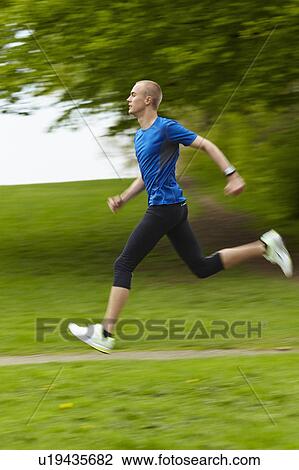Stock Image - Man running in nature. Fotosearch