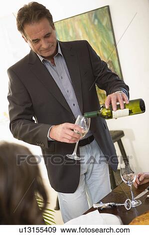 Man serving white whine View Large Photo Image Stock Photo - Man serving white whine. Fotosearch