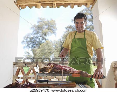 Man slicing ham View Large Photo Image Stock Image - Man slicing ham. Fotosearch