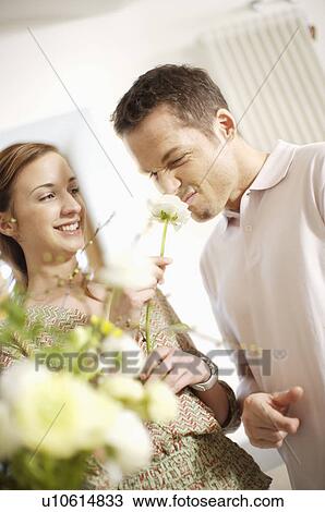 Stock Image - Man smelling a flower. Fotosearch
