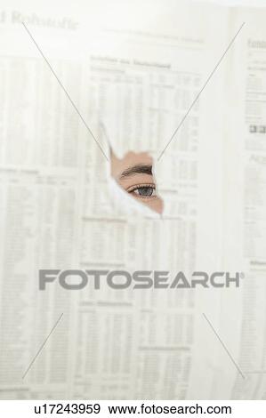 Stock Photo - Man spying through hole in newspaper. Fotosearch