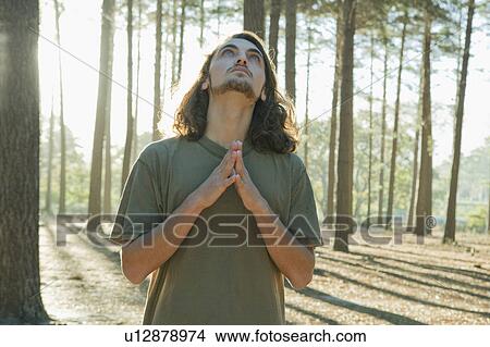 Man standing in forest View Large Photo Image Picture - Man standing in forest. Fotosearch