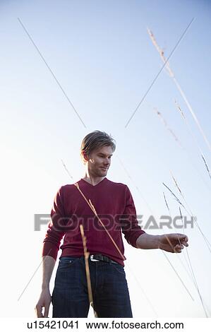 Man standing in open field View Large Photo Image Stock Image - Man standing in open field. Fotosearch