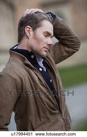 Man stroking through his hair View Large Photo Image Stock Image - Man stroking through his hair. Fotosearch