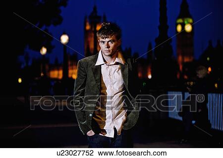 Stock Image - Man walking at night. Fotosearch